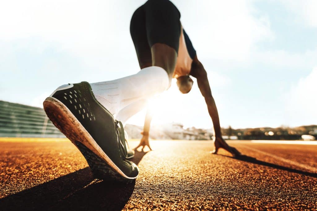 Close up on running shoe as athlete runs on track.