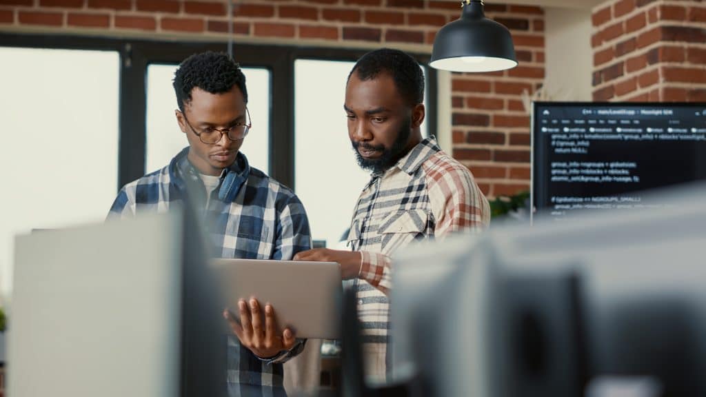 Two men looking at a computer in their office